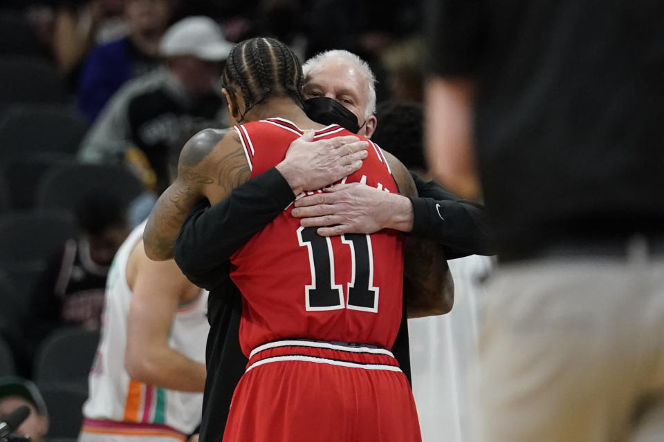 Chicago Bulls forward DeMar DeRozan (11) hugs San Antonio Spurs head coach Gregg Popovich before an NBA basketball game, Friday, Jan. 28, 2022, in San Antonio. (AP Photo/Eric Gay)