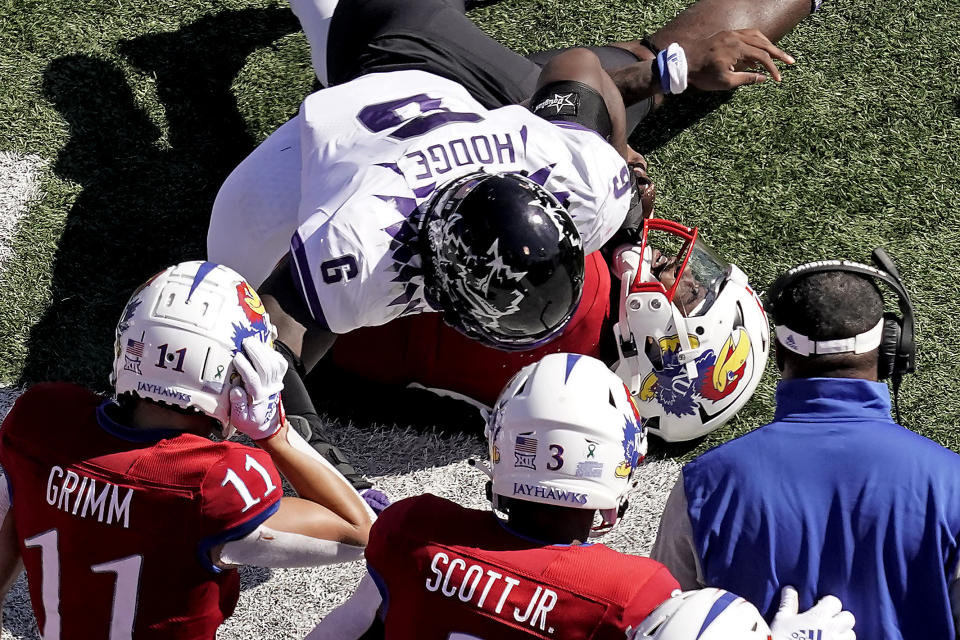 Kansas quarterback Jalon Daniels is sacked by TCU linebacker Jamoi Hodge (6) during the first half of an NCAA college football game Saturday, Oct. 8, 2022, in Lawrence, Kan. (AP Photo/Charlie Riedel)