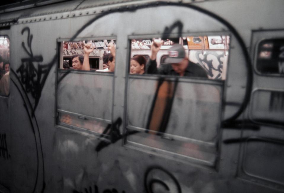 Riders in a graffiti covered Subway car in1976 in New York City, New York.