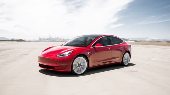 A red Tesla Model 3.