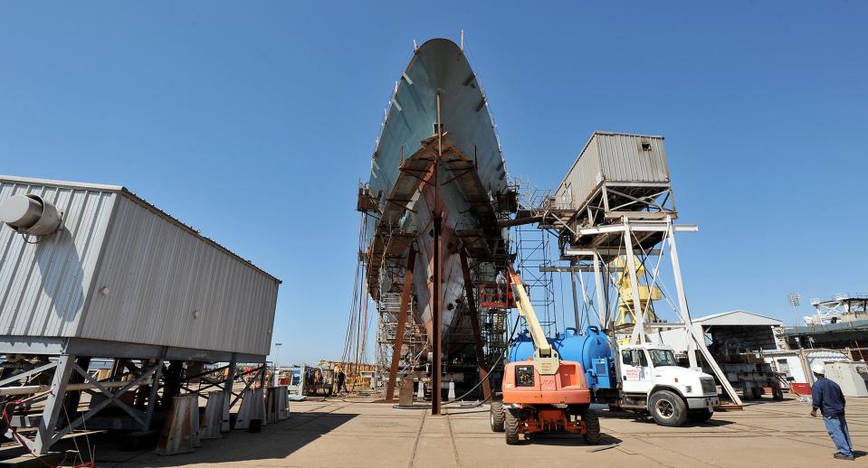 Workers with Ingalls Shipbuilding work on a U.S. Coast Guard project at the shipyard in Pascagoula, Miss.