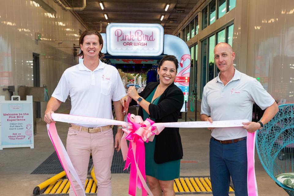 Jack Cooney, left, with West Palm Beach City Commissioner Christina Lambert and business partner Brent Andrews as they celebrated the Nov. 29 grand opening of Pink Bird Car Wash in West Palm Beach.  Cooney and Andrews are co-partners in Vybe Investments, a real estate investment firm based in West Palm Beach.