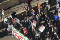 Demonstrators march through downtown Minneapolis following protests near the Hennepin County Government Center, Monday, March 8, 2021, in Minneapolis where the trial for former Minneapolis police officer Derek Chauvin began with jury selection. Chauvin is charged with murder in the death of George Floyd during an arrest last May in Minneapolis. (AP Photo/Jim Mone)