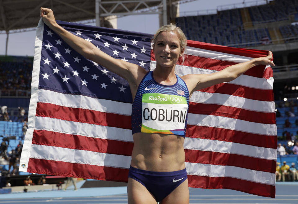 FILE - United States' Emma Coburn celebrates with the U.S. flag after winning the bronze in the women's 3000-meter steeplechase final during the athletics competitions in the Olympic stadium of the 2016 Summer Olympics in Rio de Janeiro, Brazil, on Aug. 15, 2016. Three-time U.S. Olympian Emma Coburn says her “dream of Paris is over” after breaking her ankle at the Diamond League meet in Shanghai and undergoing surgery. (AP Photo/Matt Dunham, File)