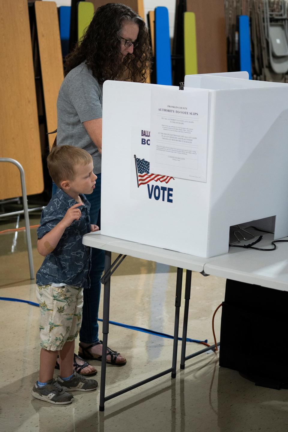 Aug 8, 2023; Columbus, Ohio, USA;  Lincoln Wensinger, 5, seemed very interested in the voting process and really wanted to help his mother, Heather Wensinger, push the buttons, as she cast her ballot in the special election on Issue 1, at Winterset Elementary School.