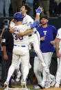 Texas Rangers Nathaniel Lowe (30) celebrates their win against the Los Angeles Angels with Josh Smith (8) after Lowe was hit by a pitch to score Travis Jankowski with bases loaded in the 13th inning of a baseball game Saturday, May 18, 2024, in Arlington, Texas. (AP Photo/Richard W. Rodriguez)