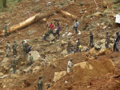 <p>Security forces search for bodies from the scene of heavy flooding and mudslides in Regent, just outside of Sierra Leone’s capital Freetown, Aug. 15 , 2017. (Photo: Manika Kamara/AP) </p>