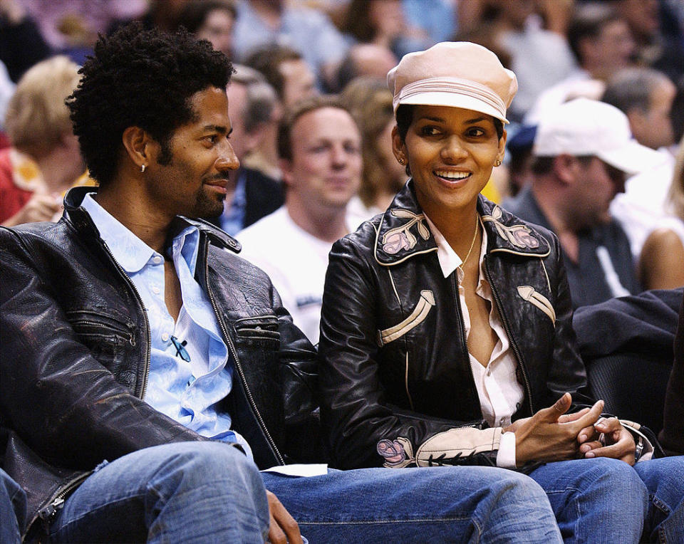 Eric and Halle seated and both wearing leather jackets and jeans