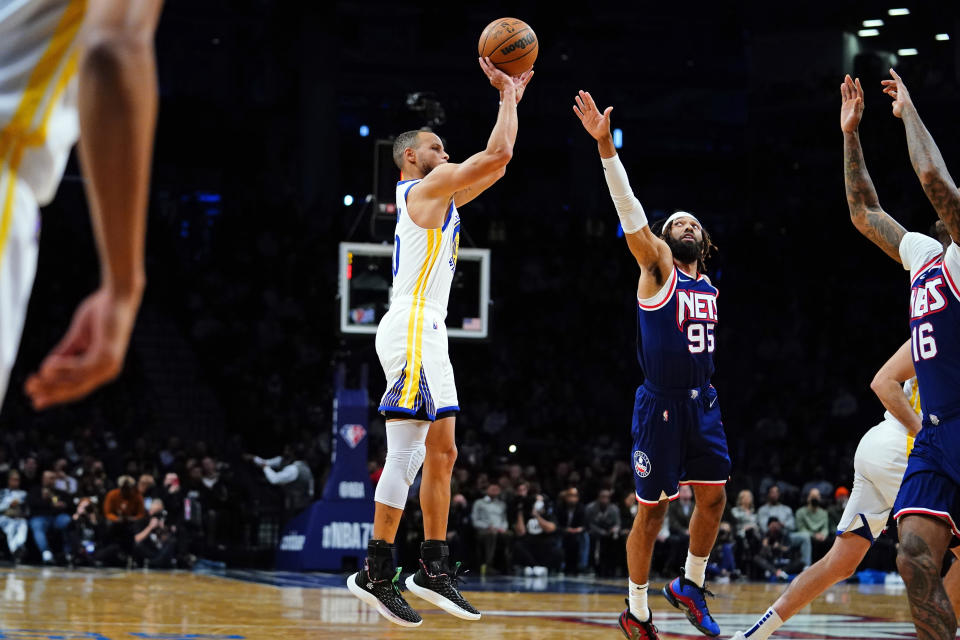 Golden State Warriors' Stephen Curry (30) shoots over Brooklyn Nets' DeAndre' Bembry (95) during the first half of an NBA basketball game Tuesday, Nov. 16, 2021 in New York. (AP Photo/Frank Franklin II)