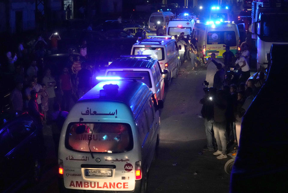 Lebanese Red Cross and Palestinian rescue team ambulances that carrying dead bodies of those who were on a boat carrying migrants from Lebanon that sank in Syrian waters, cross a border point between Lebanon and Syria, in Arida, north Lebanon, Sept. 23, 2022. Syria's health minister says several people have been killed from a boat that sank migrants from Lebanon off Syria's coast. The incident is the deadliest since a surging number of Lebanese, Syrians, and Palestinians have tried to flee crisis-hit Lebanon by sea to Europe. (AP Photo/Bilal Hussein)