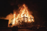 A multi-story affordable housing complex under construction near the Third Precinct, burns on Wednesday, May 27, 2020 in Minneapolis, Minn. Protests were sparked by the death of George Floyd at the hands of a Minneapolis Police officer Monday. (Mark Vancleave/Star Tribune via AP)