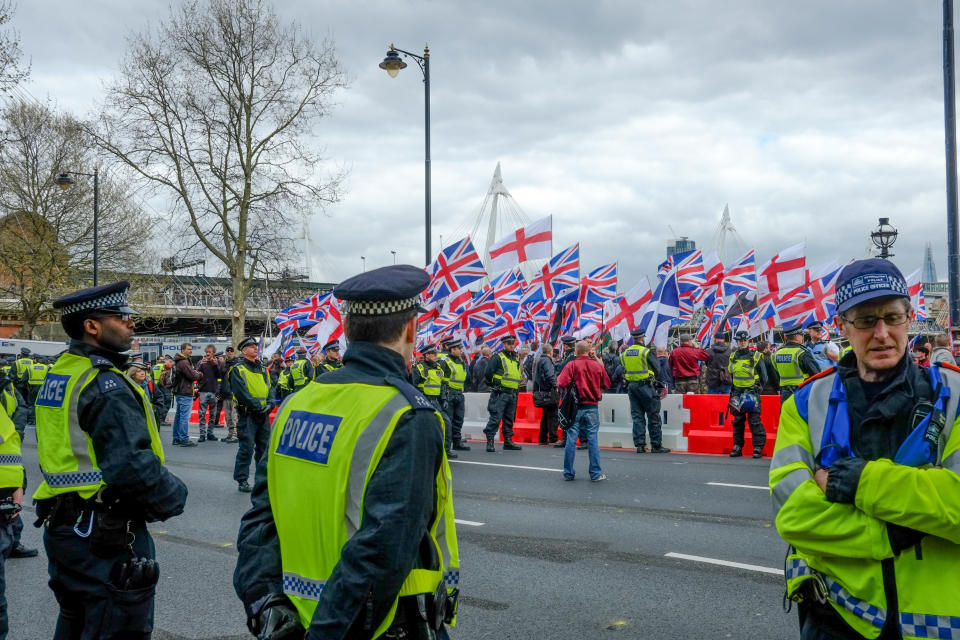 Protesters hold placards and British Union Jack flags during a protest titled 'London march against terrorism' in response to the March 22 Westminster terror attack on April 1, 2017 in London, England. The march has been organised by far-right groups English Defence League and Britain First, which also sees a counter-protest held by group 'Unite Against Fascism'. During the terror attack in Westminster, Khalid Masood killed 4 people as he drove a car into pedestrians over Westminster Bridge and stabbed PC Keith Palmer to death before being shot dead himself. (Photo by Jay Shaw Baker/NurPhoto via Getty Images)