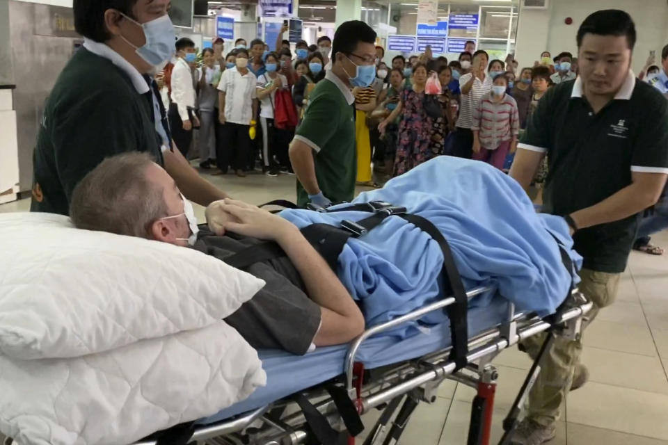 A British pilot who was Vietnam’s most critical COVID-19 patient is carried on a stretcher in Ho Chi Minh city, Vietnam, Saturday, July 11, 2020. The 42-year-old man was discharged from a hospital on Saturday, less than a week after doctors said he was virus-free and healthy enough to return home to Scotland. (AP Photo/Hieu Dinh)