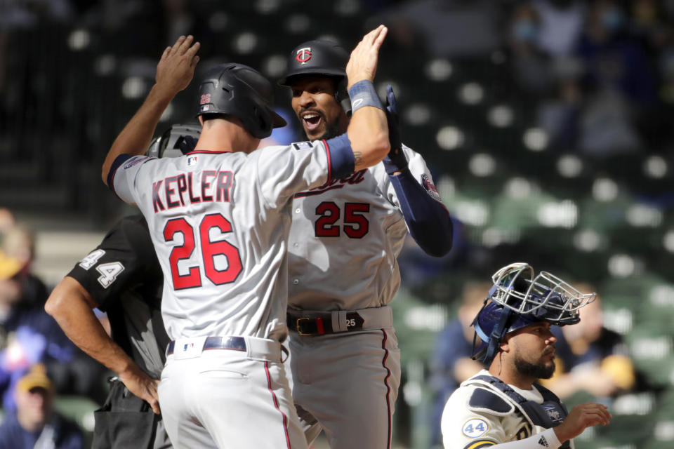 Minnesota Twins' Byron Buxton (25) is congratulated by Max Kepler (26) after hitting a two-run home run during the seventh inning of an opening day baseball game against the Milwaukee Brewers, Thursday, April 1, 2021, in Milwaukee. (AP Photo/Aaron Gash)