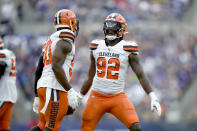 Cleveland Browns defensive end Chad Thomas (92) celebrates with defensive end Chris Smith (50) after recovering a fumble by Baltimore Ravens running back Mark Ingram during the second half of an NFL football game Sunday, Sept. 29, 2019, in Baltimore. (AP Photo/Gail Burton)