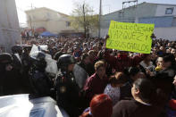 A man holds a sign with names of inmates as he stands with others outside the of the Topo Chico prison in Monterrey, Mexico, February 11, 2016. REUTERS/Daniel Becerril