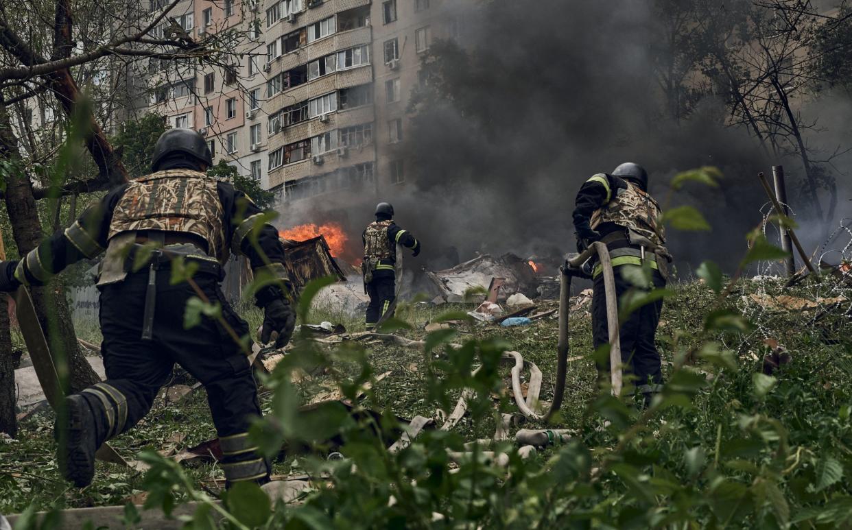 Ukrainian emergency services fight a fire after a Russian air strike Kharkiv
