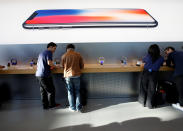 <p>Customers are seen under a picture of Apple’s new iPhone X after it goes on sale at the Apple Store in Tokyo’s Omotesando shopping district, Japan, November 3, 2017.REUTERS/Toru Hanai </p>