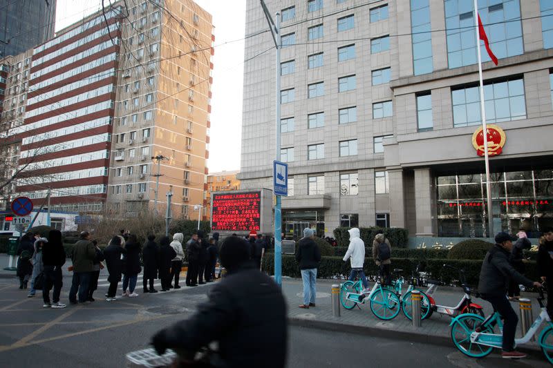 People line up outside Chaoyang People's Court before a court hearing of Teresa Xu's suit against a Beijing hospital, in Beijing