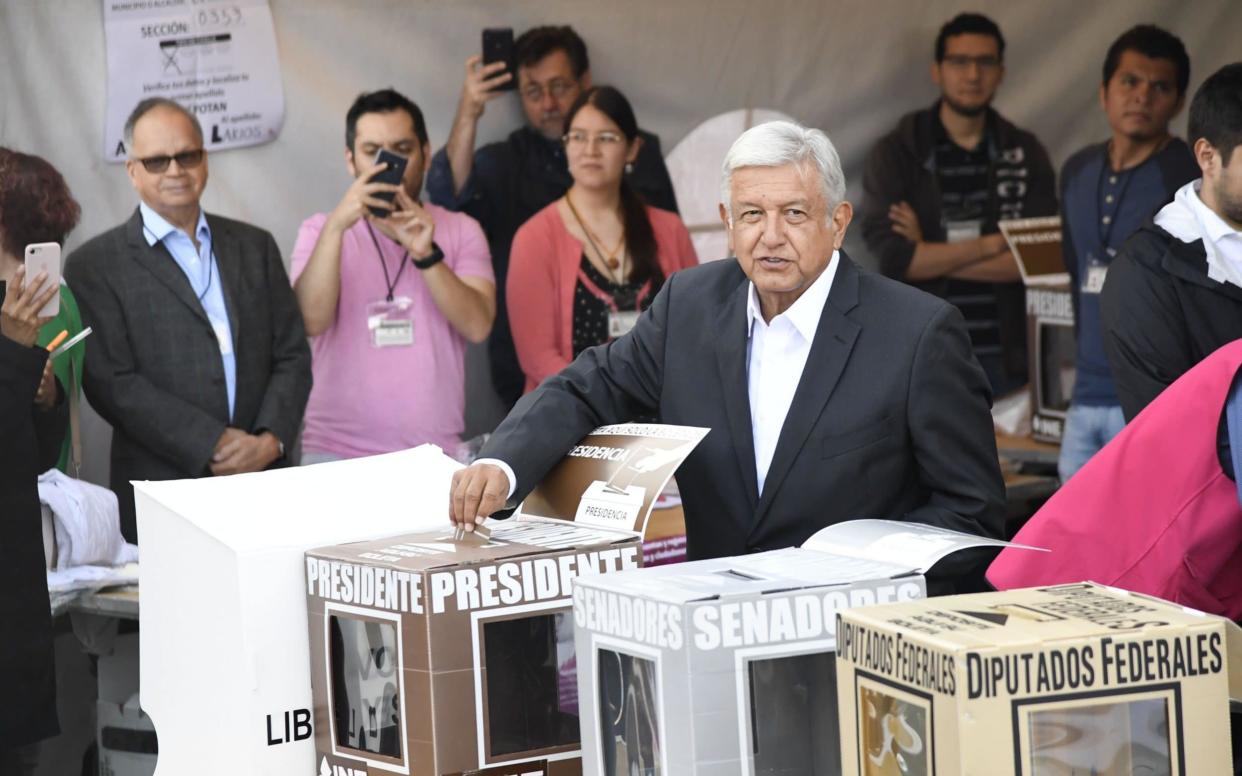 Andres Manuel Lopez Obrador, the frontrunner to be elected president of Mexico, casts his vote in Mexico City on Sunday - AFP
