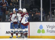 Colorado Avalanche center Alex Newhook, center, celebrates his goal against the Seattle Kraken with Artturi Lehkonen (62) and Jacob MacDonald (26) during the second period of an NHL hockey game Saturday, Jan. 21, 2023, in Seattle. (AP Photo/Lindsey Wasson)