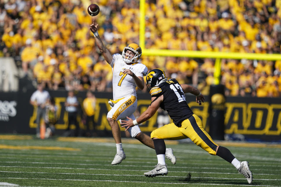 Kent State quarterback Dustin Crum (7) throws a pass over Iowa defensive end Joe Evans (13) during the first half of an NCAA college football game, Saturday, Sept. 18, 2021, in Iowa City, Iowa. (AP Photo/Charlie Neibergall)