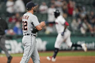 Detroit Tigers relief pitcher Michael Fulmer, left, waits for Cleveland Indians' Franmil Reyes, right, to run the bases on a solo home run during the sixth inning in a baseball game Friday, April 9, 2021, in Cleveland. (AP Photo/Tony Dejak)