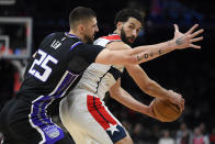 Sacramento Kings center Alex Len, left, guards Washington Wizards forward Anthony Gill during the first half of an NBA basketball game Thursday, March 21, 2024, in Washington. (AP Photo/John McDonnell)