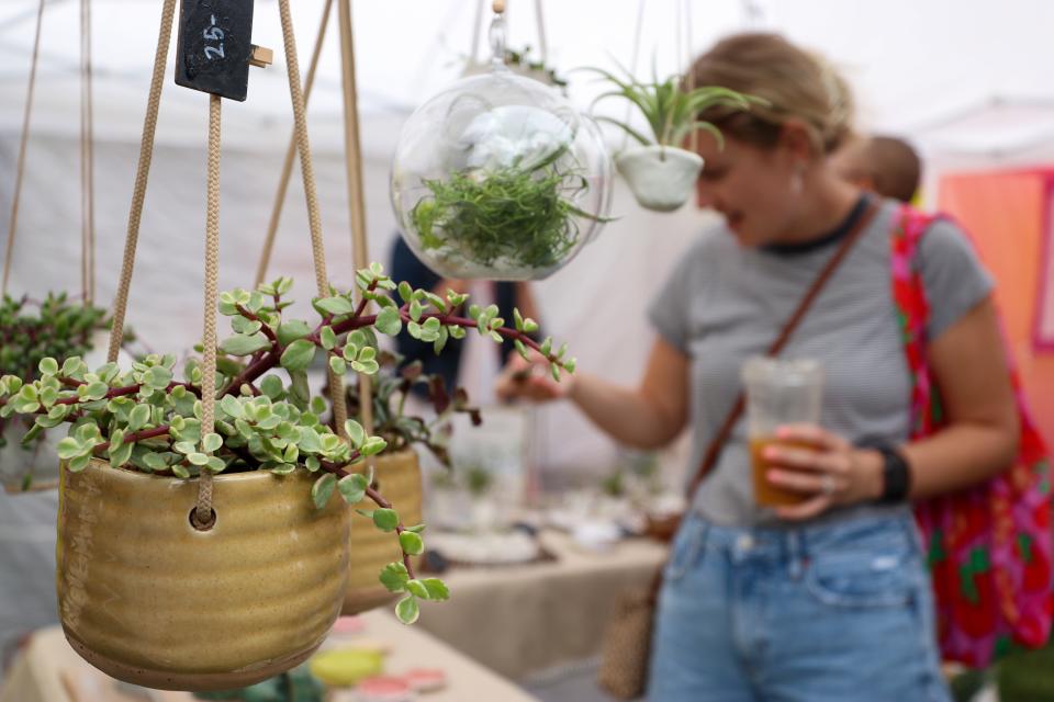 Hanging plant holders from Pot Head Pottery are browsed, Saturday, June 11, 2022, at Washington Park Cincinnati