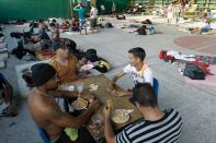 Cuban migrants eat and play dominoes during lunch time at a temporary shelter in a school in the town of La Cruz, Costa Rica, near the border with Nicaragua, November 16, 2015. More than a thousand Cuban migrants hoping to make it to the United States were stranded in the border town of Penas Blancas, Costa Rica, on Monday after Nicaragua closed its border on November 15, 2015 stoking diplomatic tensions over a growing wave of migrants making the journey north from the Caribbean island. REUTERS/Juan Carlos Ulate