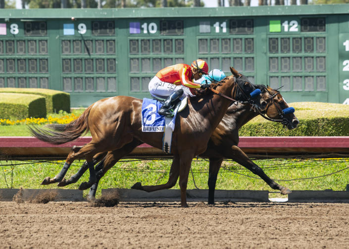 In this photo provided by Benoit Photo, Classier and jockey Mike Smith, right, hold off stablemate Defunded and jockey Abel Cedillo to win the Grade III $150,000 Los Alamitos Derby horse race, Sunday, July 4, 2021, at Los Alamitos Race Course, in Cypress, Calif. (Benoit Photo via AP)
