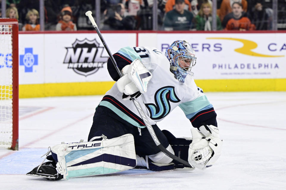 Seattle Kraken goaltender Philipp Grubauer makes a glove-save during the second period an NHL hockey game against the Philadelphia Flyers, Sunday, Feb. 12, 2023, in Philadelphia. (AP Photo/Derik Hamilton)