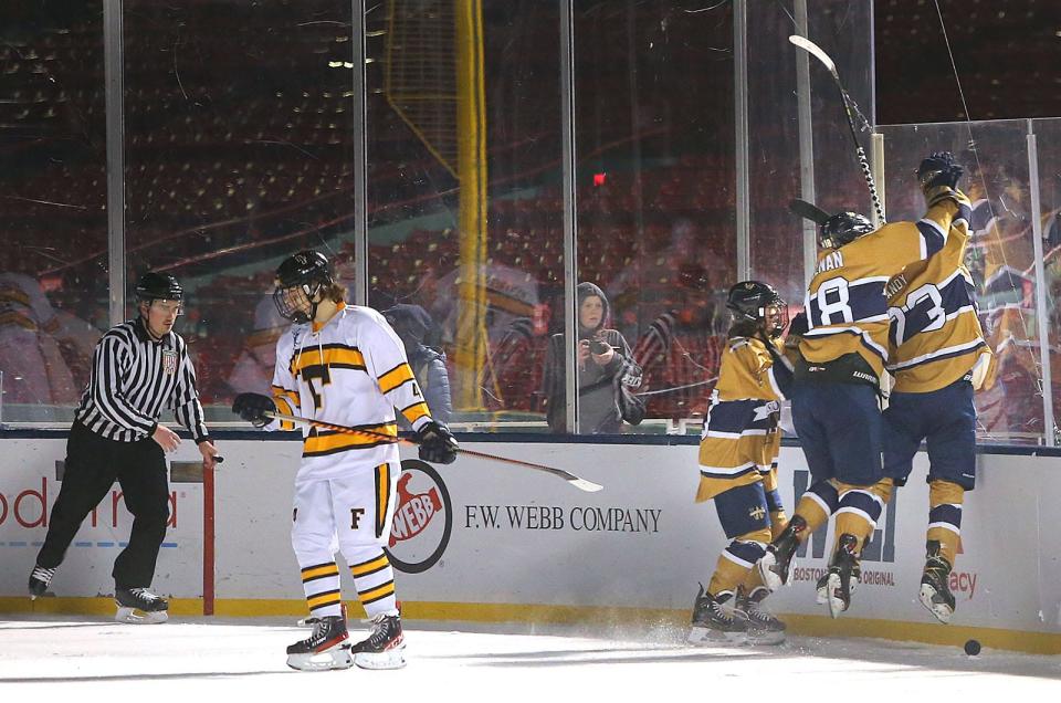 Members of the Archbishop Williams High boys hockey team celebrate a goal during a 5-1 win over Bishop Fenwick in a scrimmage at Fenway Park on Tuesday, Jan. 10, 2023. High school teams across the state got a chance to play on the ice after the NHL Winter Classic last week.