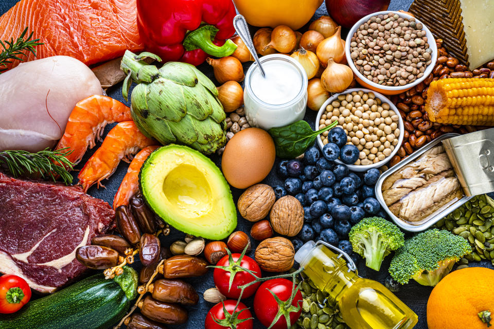 Overhead view of a large group of healthy raw food for flexitarian mediterranean diet. The composition includes salmon, chicken breast, canned tuna, cow steak, fruits, vegetables, nuts, seeds, dairy products, olive oil, eggs and legumes. (Photo via Getty Images)