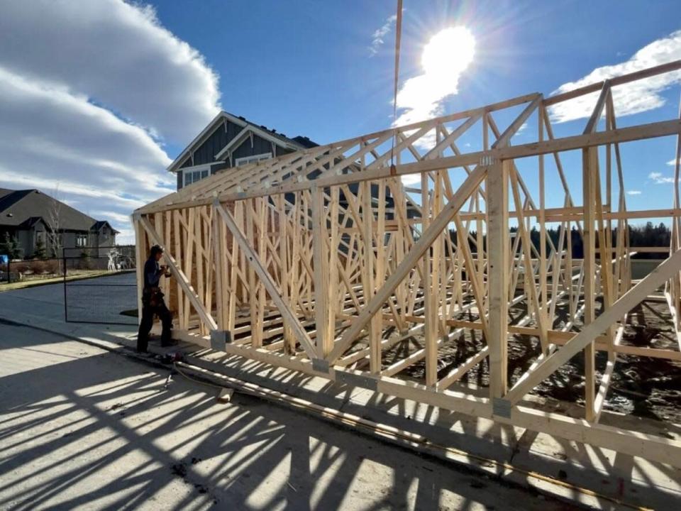 A framer puts together part of a new home being built in southeast Calgary. The supply chain disruption has affected the price of homes and how long it takes to build them in Calgary. (Bryan Labby/CBC - image credit)
