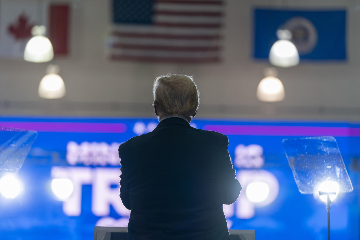 Former President Donald Trump is seen from behind as he speaks at a campaign rally.