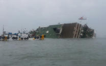 South Korea rescue helicopter and fishing boats try to rescue passengers from a passenger ship in water off the southern coast in South Korea, Wednesday, April 16, 2014. The South Korean passenger ship carrying more than 470 people, including many high school students, is sinking off the country's southern coast Wednesday after sending a distress call, officials said. There are no immediate reports of causalities. (AP Photo/Yonhap)