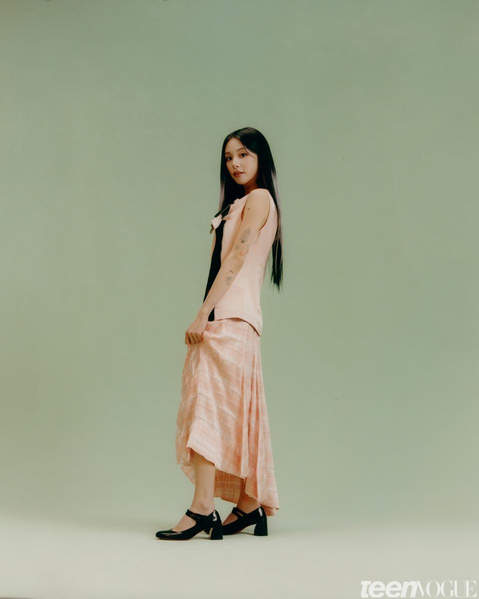 Chaeyoung wears a [3.1 Phillip Lim top and skirt](https://31philliplim.com/) and [Christian Louboutin shoes](https://us.christianlouboutin.com/us_en/).