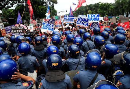 Anti-riot policemen block protesters denouncing the visit of U.S. Secretary of State John Kerry and the Supreme Court's decision to uphold, with finality, the constitutionality of the Enhanced Defense Cooperation Agreement (EDCA) during a protest outside the U.S. embassy in metro Manila, Philippines July 27, 2016. REUTERS/Romeo Ranoco