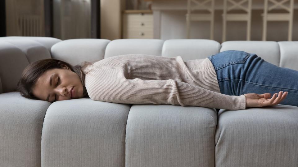 Woman lying asleep on the sofa