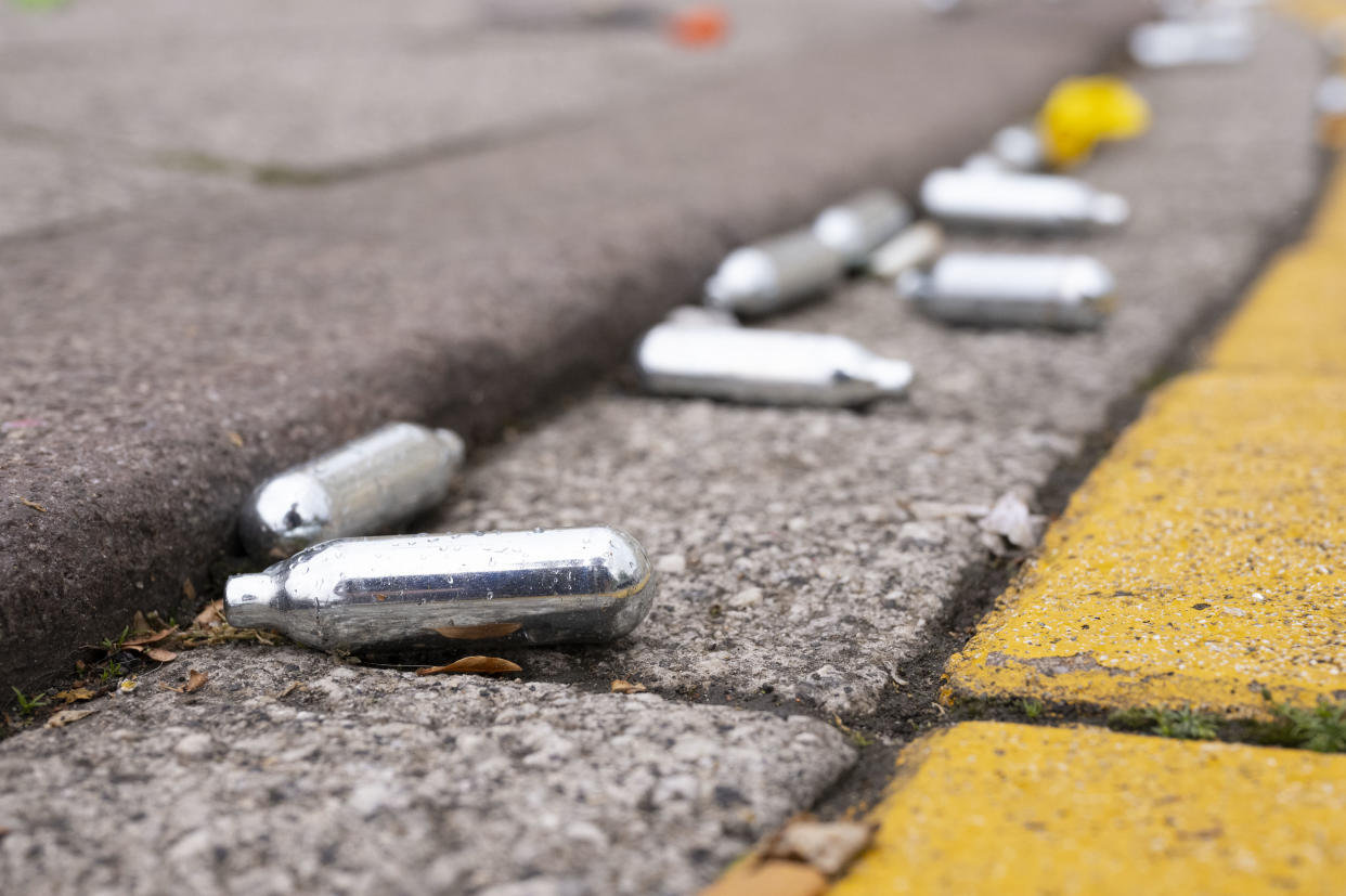 CARDIFF, UNITED KINGDOM - JUNE 27: Used metal canisters of nitrous oxide, also known as hippy crack or happy gas, left on the floor at Roald Dahl Plass in Cardiff Bay following a lockdown party on June 27, 2020 in Cardiff, United Kingdom. The First Minister of Wales Mark Drakeford has announced that all non-essential shops will be allowed to open their doors again in Wales from Monday but people will be asked to continue to 