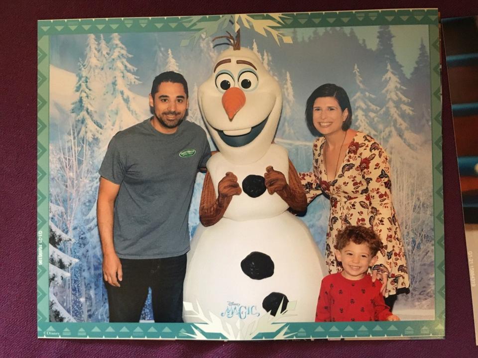 amanda adler and family posing with frozen character on cruise ship