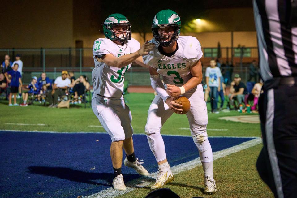 Thatcher Eagles quarterback Brett Jones (3) and wide receiver back Dylan Riney (31) celebrate Jones’ touchdown against the Paradise Honors Panthers at Paradise Honors High School in Surprise on Aug. 18, 2023.