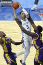 Kentucky's B.J. Boston, top, shoots while defended by LSU's Ja'Vonte Smart, left, and Darius Days (4) during the second half of an NCAA college basketball game in Lexington, Ky., Saturday, Jan. 23, 2021. (AP Photo/James Crisp)