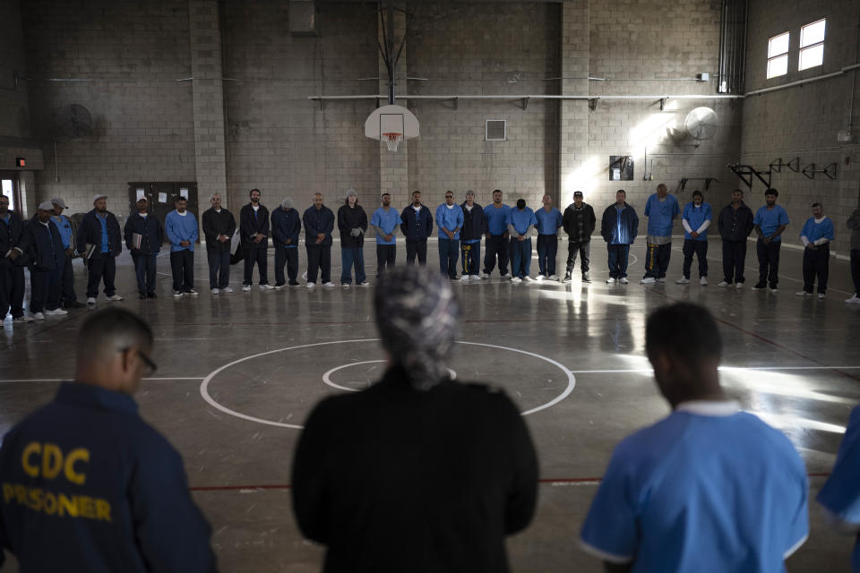 Prisoners form a large circle during a guided meditation in Valley State Prison's gymnasium in Chowchilla, Calif., Friday, Nov. 4, 2022. In a nation that incarcerates roughly 2 million people, the COVID pandemic was a nightmare for prisons. The highly contagious virus disrupted the very educational and rehabilitative programs prisoners most desperately need. (AP Photo/Jae C. Hong)