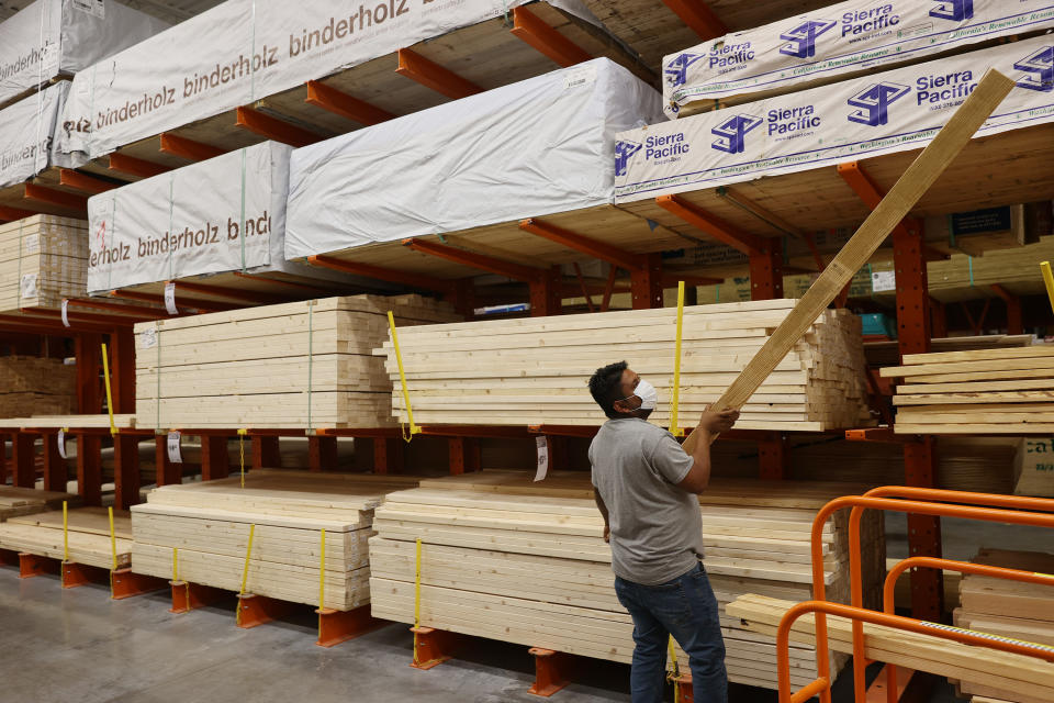 DORAL, FLORIDA - MAY 27: Enrique Matamoros shops for lumber at a Home Depot store on May 27, 2021 in Doral, Florida. According to the National Association of Home Builders, lumber prices went up 300% last year. Factors driving the price increase are more demand and growing production, labor, and transportation costs.
 (Photo by Joe Raedle/Getty Images)