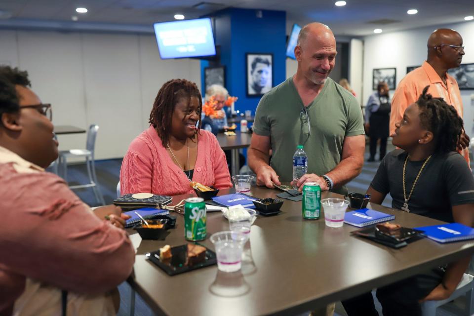 Detroit Lions Former Linebacker Chris Spielman (center right) talks with Jarrell Gaines, 11, of Detroit, who attended the Crucial Catch event with is grandmother Danielle Dillard, 53, of Detroit, (center left) who is a cancer survivor, and his mother Vanishia Starling, 34, of Detroit 
during the event at Ford Field in Detroit on Wednesday, Oct. 4, 2023. Dillard was diagnosed with lung cancer in March and The Black United Fund invited them to the event.