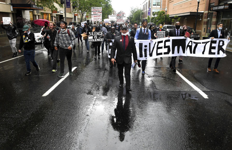 Kurtis Robinson, president of the Spokane chapter of the NAACP, leads a Black Lives Matter protest march amid a downpour Sunday, June 14, 2020, in Spokane, Wash. (Tyler Tjomsland/The Spokesman-Review via AP)