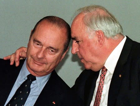 FILE PHOTO: German Chancellor Helmut Kohl (R) talks to French President Jacques Chirac during a news conference