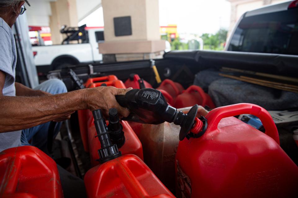 Nelson Morales fills gas tanks at a Race Trac in Fort Myers in anticipation of Tropical Storm Idalia on Monday, August 28, 2023. The storm is expected to grow into a hurricane.